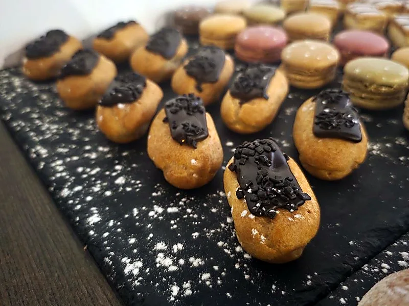 Un buffet sucré sur ardoise : éclairs au chocolat et macarons
